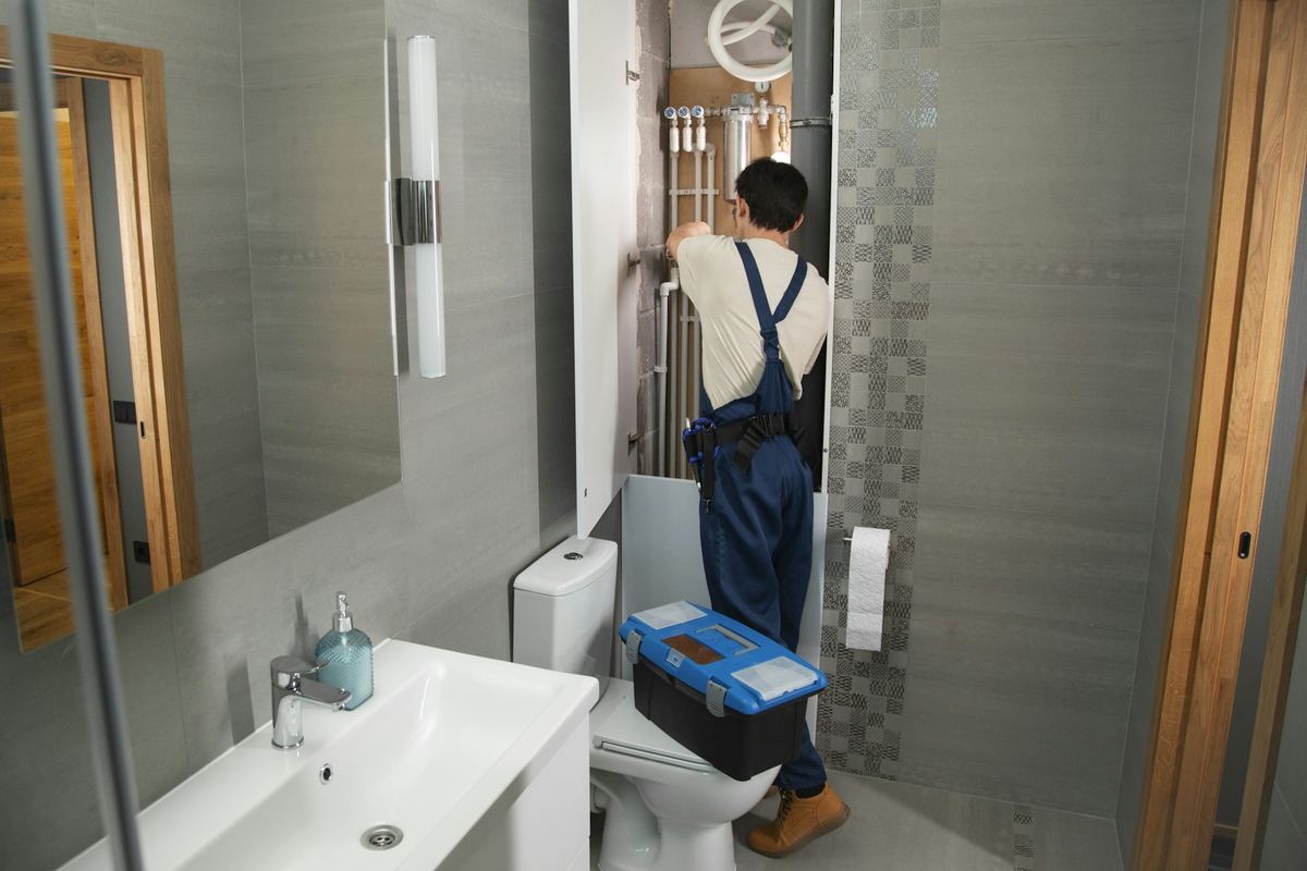Our plumber working in a customer's bathroom