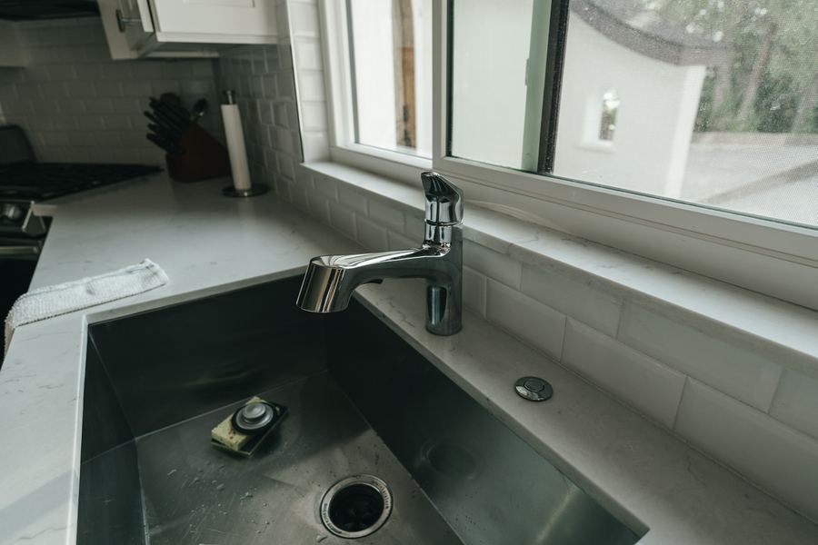 Kitchen sink with the drain and disposal visible