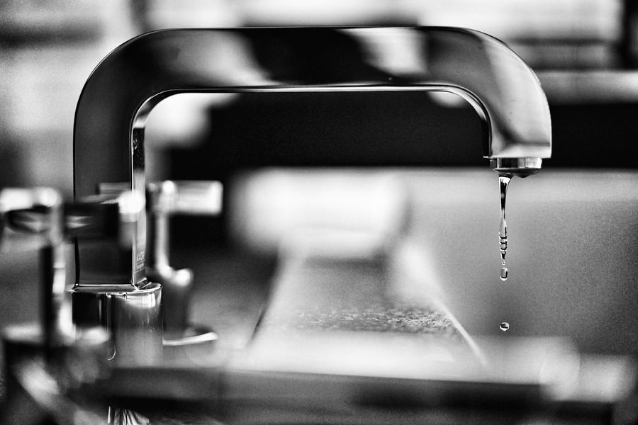 A faucet dripping into a sink